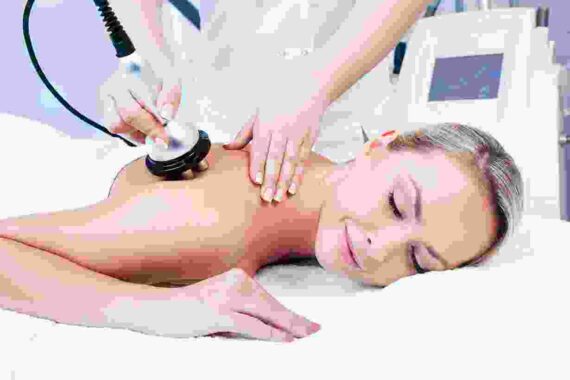 A woman getting her back examined by an esthetician.