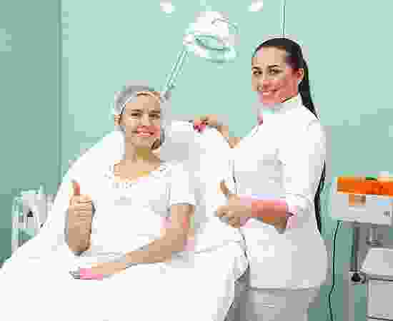 A woman sitting in front of another woman.