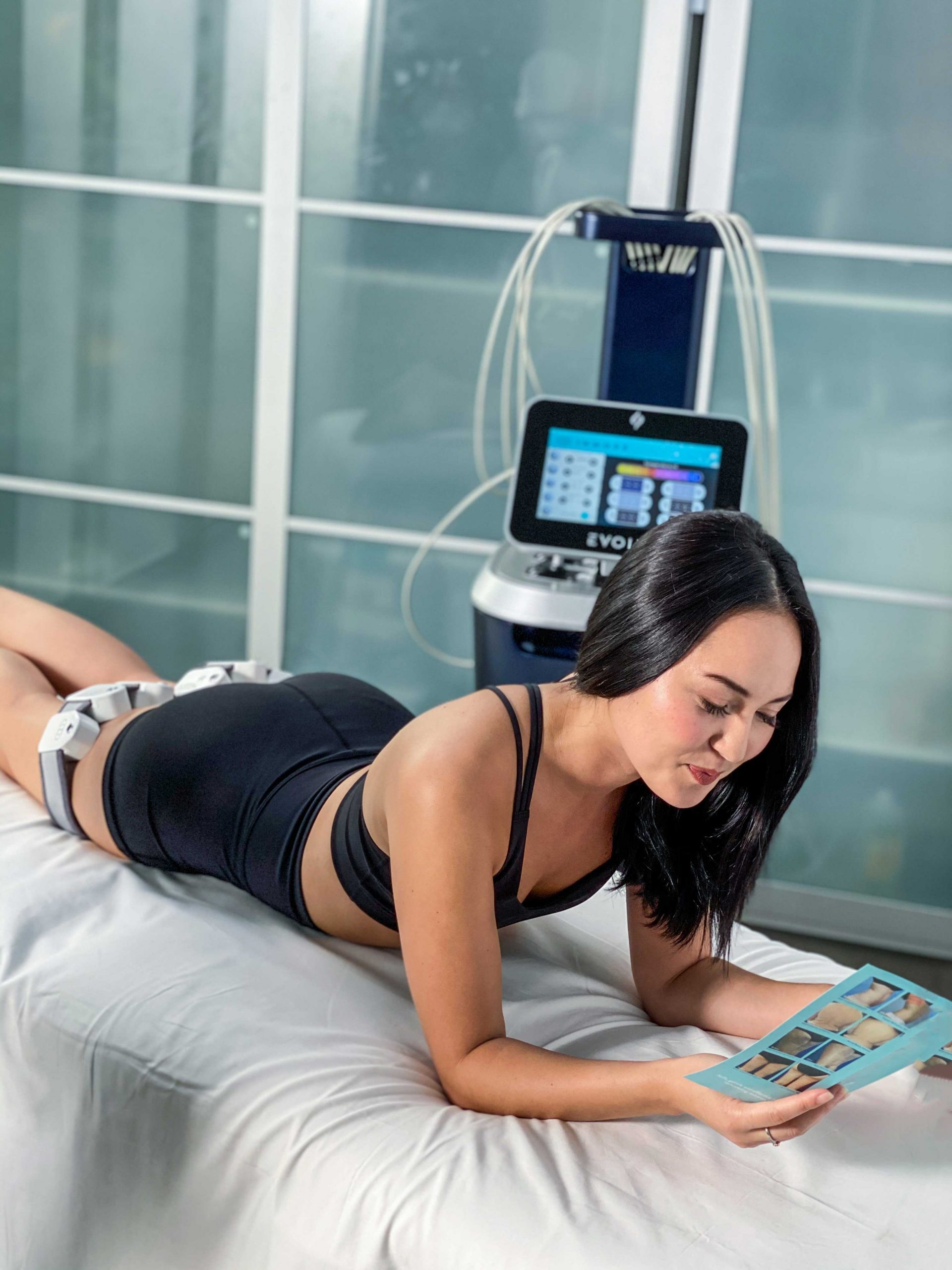 evolve-model-preview-1 A woman is laying on the bed and reading